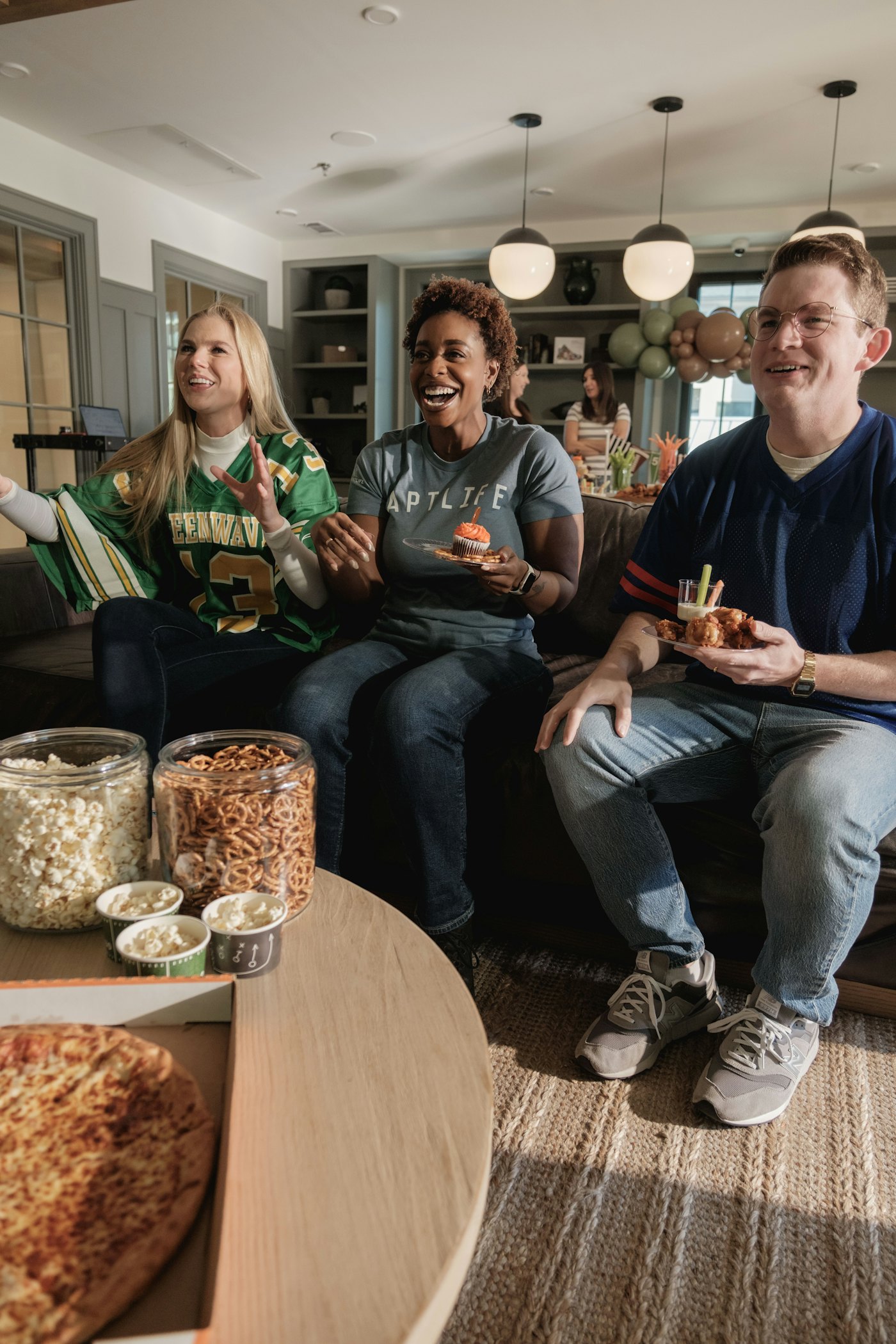 Friends sharing popcorn and laughing together