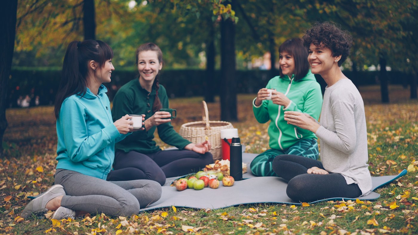 Friends enjoying snacks together at a picnic